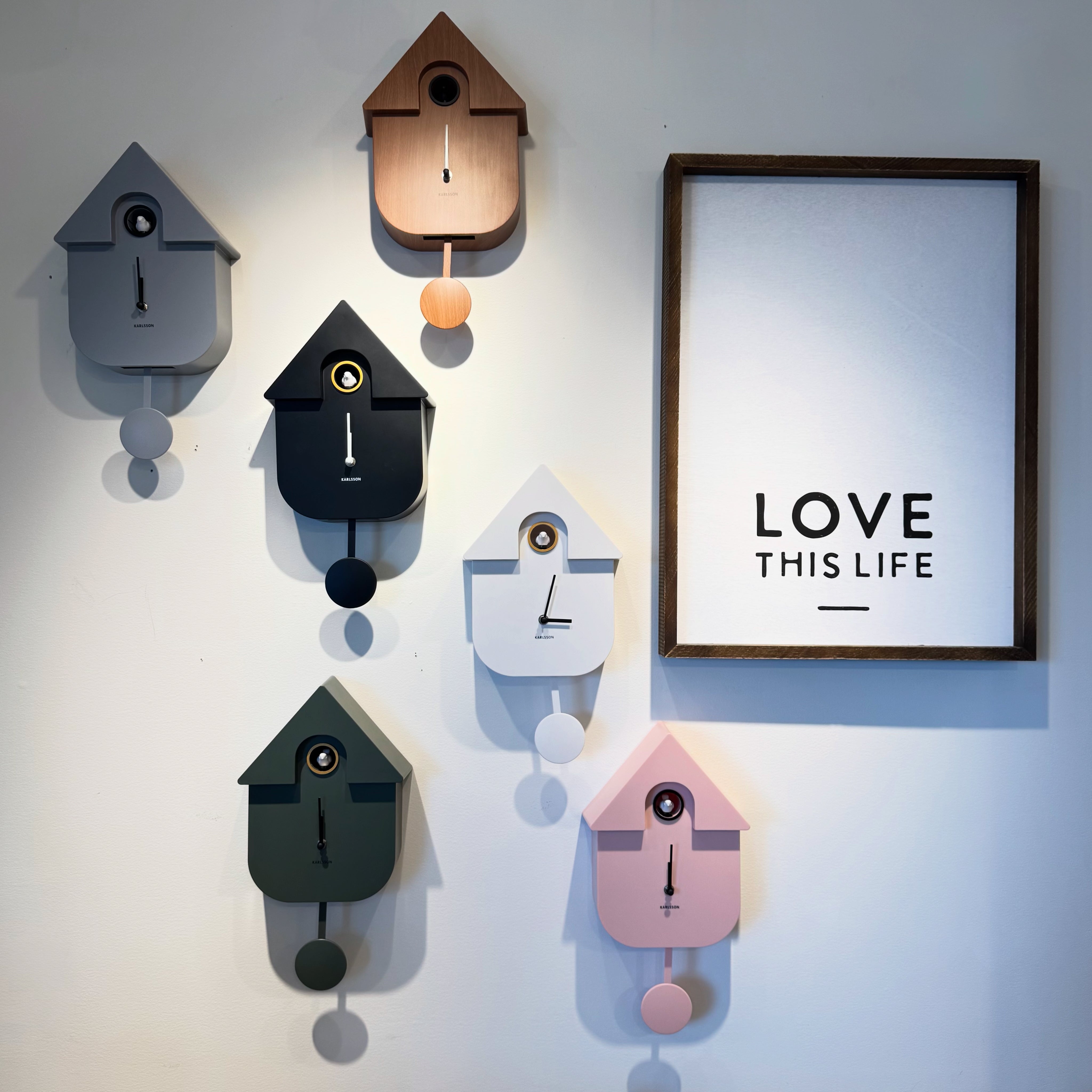 six different coloured cuckoo clocks and a poster saying Love this Life six different coloured cuckoo clocks and a poster saying Love this Life