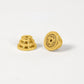 Two gold guitar tuning pegs on a white background