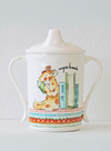 Children's sippy cup with a giraffe illustration on a white background