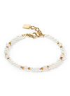 View of a bracelet made from freshwater pearls and rose quartz with gold accents.