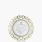 Voluspa candle in a decorative tin with gold and white design on a white background