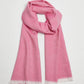 Pink scarf with white lace trim on a light gray background