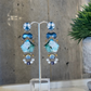 a pair of long earrings with blue and white stones that feel like the ocean