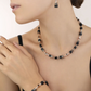 Model wearing the GeoCUBE onyx collection featuring earrings, a necklace and a bracelet 