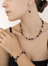 Model wearing the GeoCUBE onyx collection featuring earrings, a necklace and a bracelet 