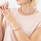 Model wearing the pink geoCUBE bracelet, necklace and earrings