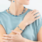 Model wearing the turquoise GeoCUBE collection featuring a necklace, earrings and a bracelet