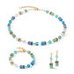 View of the turquoise and gold GeoCUBE collection featuring a necklace, bracelet and earrings.
