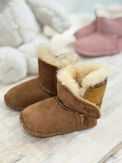 Angled view of a pair of chestnut coloured booties with a cosy lining