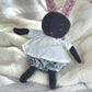 Front view of a dark blue bunny with pink ears wearing cotton clothes