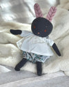 Front view of a dark blue bunny with pink ears wearing cotton clothes