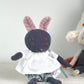 Front view of a dark blue bunny with pink ears wearing cotton clothes