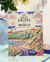 Cover of the book 'Epic Drives of the World' featuring an illustration of a car on a road with mountains and a blue sky in the background.