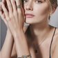 Model posing with a stack of 4 silver bracelets on her arm
