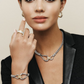 A model posing with silver and gold jewelry in a black blazer