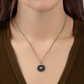 Necklace with a pendant worn by a person, close-up view.