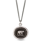 View of a silver pendant necklace with a bear on the medallion.