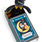 Plush toy mouse in a box with a card featuring another mouse illustration on a white background