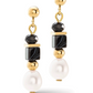 Front view of a pair of gold, onyx and pearl dangle earrings