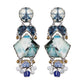 Pair of long earrings with blue, white  and patterned stones on a white background