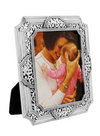 Beautifully designed silver photo frame with intricate swirled details.