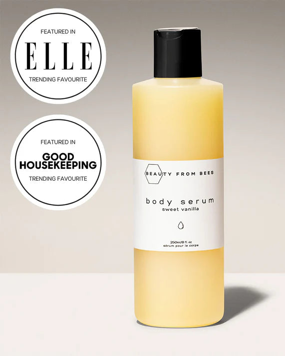 Body serum bottle with 'Beauty from Bees' branding and certification badges on a neutral background