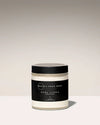 Jar of body crème with black lid and label on a light background